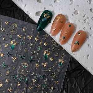 Golden butterfly and star nail stickers with dark green and nude manicure effects