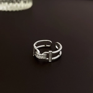 Close-up of adjustable silver bow ring with sparkling cubic zirconia on dark leather