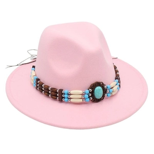 Detail of pink fedora hat featuring ethnic beaded band and turquoise stone accent