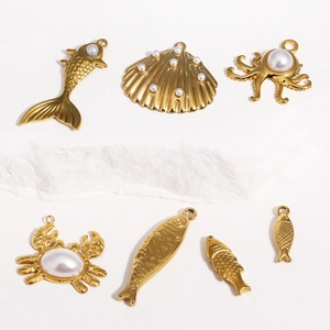 Detailed view of gold marine pendants including pearl octopus, crab, and shell charms