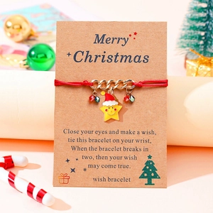 Detail of red Christmas wish bracelet with star pendant on kraft card packaging