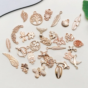 Close-up of golden vintage alloy charms in various shapes like leaves and feathers