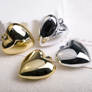 Mirror-plated heart pendants in gold and silver colors with integrated hanging loops