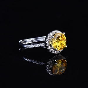 Fashionable halo silver ring with large round yellow gemstone and pavé accents