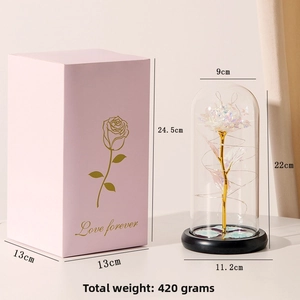 Detail view of colorful gold foil rose in glass dome with pink Love Forever gift box