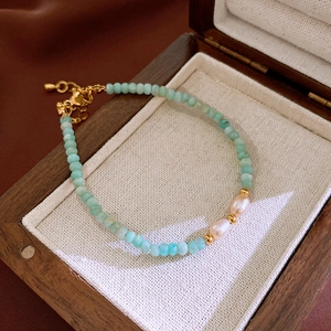Detailed close-up of Amazonite beads and freshwater pearls on a gold-plated link bracelet