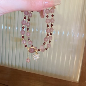 Detail of double-layer bracelet with pink strawberry quartz and red garnet beads
