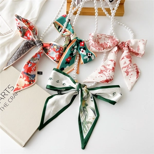 French vintage pearl necklace with four colorful silk scarf designs shown in a flat lay