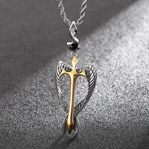 Detail of a gold sword pendant with silver wings and black rhinestone on a steel chain