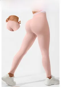 Detailed back view of pink high waist seamless yoga leggings with peach lift and gym text