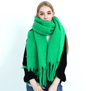 Detail shot of green tie-dye plaid cotton scarf with handmade knotted tassels
