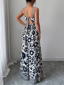 Detail of elegant black and white print jumpsuit featuring a tie back and open back design