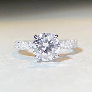 Macro shot of 3-carat moissanite ring showing brilliant fire and four-prong silver setting