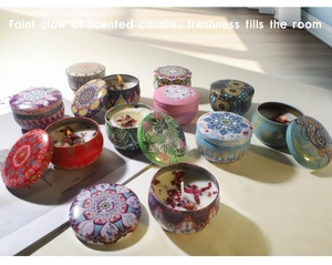 Close-up of bohemian metal tin scented candles with dried flowers and natural light