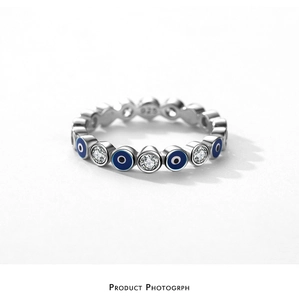 Detailed macro view of S925 sterling silver evil eye ring with blue enamel and zircons