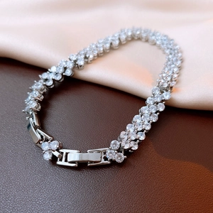 Macro view of silver clasp and double-row zircon pavé on the luxury fashion bracelet