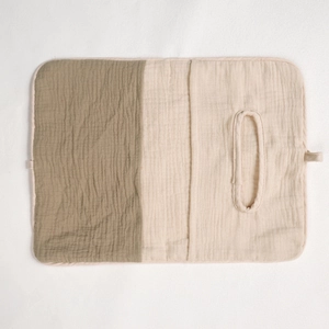 Detail of soft double-layer muslin fabric storage bag in olive green and beige