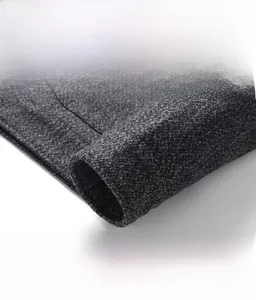 Detailed macro view of high-quality dark grey wool blend fabric and stylish coat cuffs