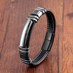 Detail of handmade black braided leather men's bracelet with polished magnetic steel clasp