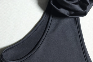 Detailed close-up of the fine stitching and stretchy knit fabric of the black sexy dress
