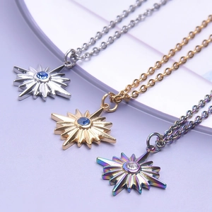 Three celestial star pendant necklaces with rhinestones in silver, gold, and iridescent finishes