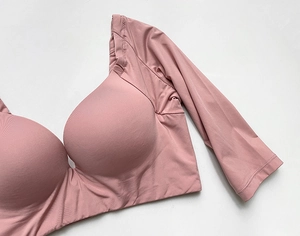 Close-up of pink long-sleeved seamless bodysuit with integrated molded cups