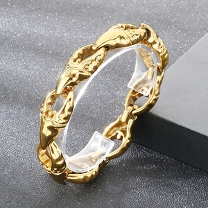 Macro shot of gold-plated punk crab claw links with a polished finish and detailed texture