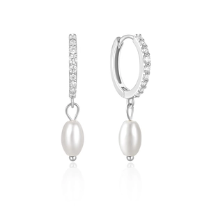 Macro shot of silver drop earrings featuring white pearls and sparkling zircon pavé