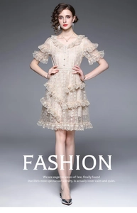 Close-up of beige lace dress detailing ruffled V-neck and delicate embroidery texture