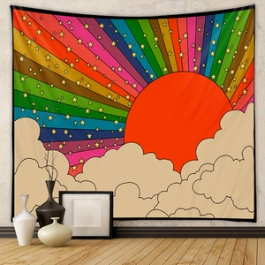 Detail of bohemian sun and rainbow tapestry with stars and clouds on a textured wall