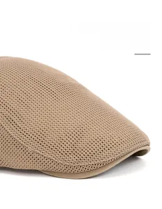 Detail of khaki mesh newsboy cap showing the foldable extended brim and breathable fabric