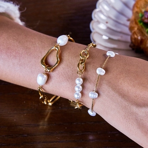 Three-piece layered gold chain bracelet set with baroque pearls and geometric charms