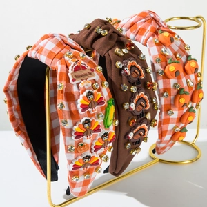 Close-up of Thanksgiving headbands with turkey and pumpkin charms and rhinestones
