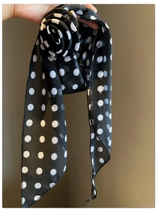 Detailed close-up of a vintage black and white polka dot chiffon flower scarf necklace