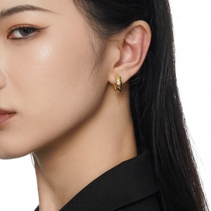 Minimalist S925 silver hoop earrings with hammered gold texture worn by a model
