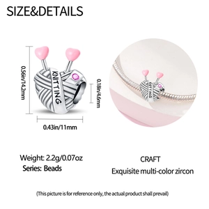 Detailed view of silver knitting yarn charm with pink heart and zircon for DIY bracelets