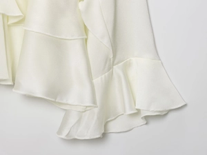 Detailed macro shot of layered white ruffle fabric showing delicate chiffon texture