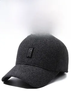 Detailed view of thick dark grey tweed texture and fashion leather patch on men's winter cap