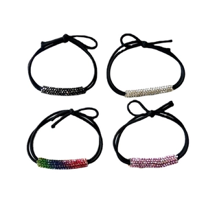 Set of four elastic hair ties with sparkling rhinestone tubes in black, white and pink