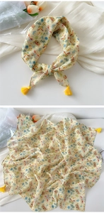 Detail of yellow cotton linen scarf with butterfly floral print and elegant tassels