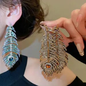 Luxurious silver feather earrings with blue crystals and sparkling rhinestone accents