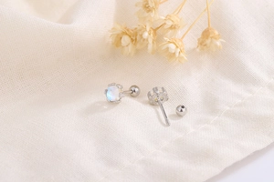 Macro detail of S925 moonstone stud earrings featuring secure screw back closure design