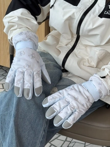 Detail of cute rabbit print ski gloves featuring reinforced fingertips and velcro wrist strap