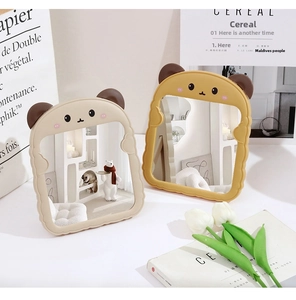 Detail of beige and yellow foldable desk mirrors with cute cartoon bear ears design
