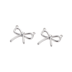 Close-up of bright silver bow-shaped stainless steel charms with hanging loops for DIY jewelry