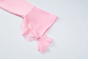 Detail of pink mesh ruffle cuffs and fabric texture of the slim fit two-piece set
