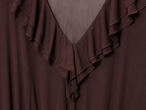 Detailed close-up of the V-neckline featuring layered ruffle trim on dark brown dress