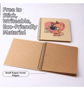 Close-up of a vintage 6-inch kraft paper scrapbook with spiral binding and cat illustration