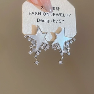 Close-up of S925 silver star earrings with mother of pearl and zircon tassels