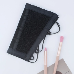 Arm-mounted makeup brush cleaning sponge sleeve with elastic straps and black mesh texture